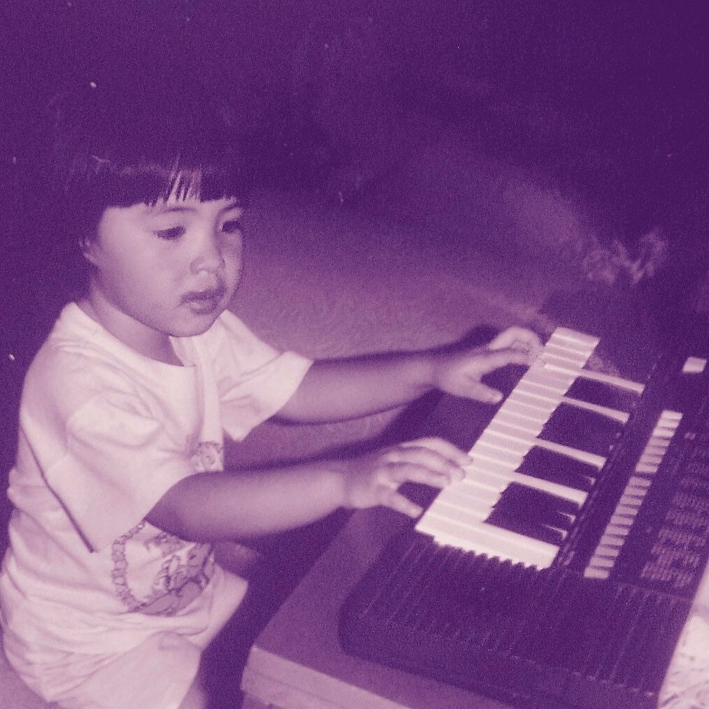 Younger Ella Anchor playing keyboard