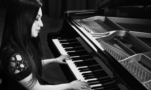 Black and White picture of Ella Anchor Playing Piano